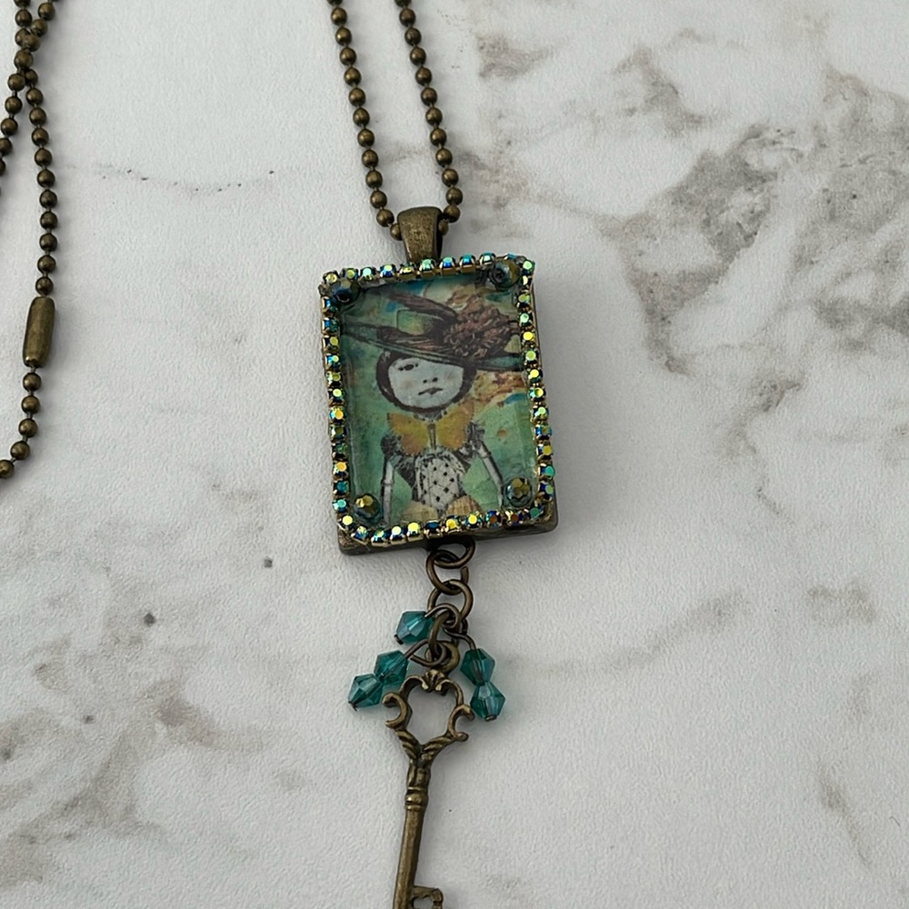 Handmade Cabachon Pendant necklace. Antique Gold. Unique design. Lady in hat.